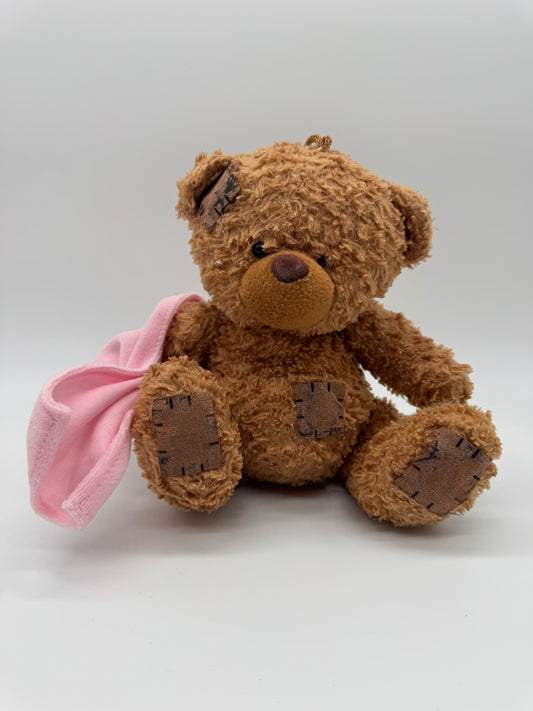 Teddybär mit Tuch verletzt